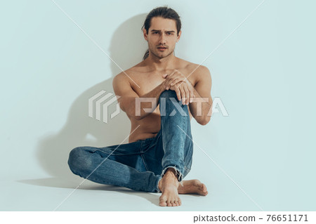 Muscle strong beautiful stripped male model in denim jeans on white isolated font background with shadow Muscle strong beautiful stripped male model in denim jeans on white isolated font background with shadow 76651171