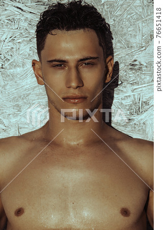 Strong face muscle male model in the open summer shower on the vacation pool background with blue water on the nature beach on the sunset Strong face muscle male model in the open summer shower on the vacation pool background with blue water on the nature beach on the sunset 76651418