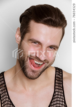 Handsome muscled strong face male model in fashion cloathes on white isolated font background Handsome muscled strong face male model in fashion cloathes on white isolated font background 76654329