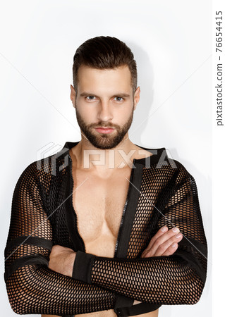 Handsome muscled strong face male model in fashion cloathes on white isolated font background Handsome muscled strong face male model in fashion cloathes on white isolated font background 76654415