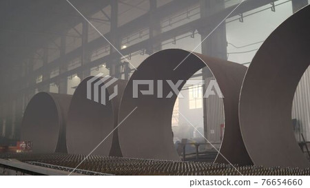 Huge metal pipes. Industrial zone, steel pipelines and cables. Production of large diameter pipes 76654660