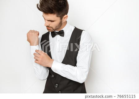 Muscle strong beautiful stripped male model in toxedo on white isolated font background Muscle strong beautiful stripped male model in toxedo on white isolated font background 76655115