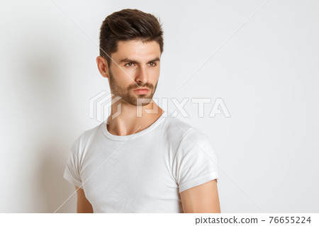 Muscle strong beautiful stripped male model in denim jeans and white tshirt on white isolated font background with shadow Muscle strong beautiful stripped male model in denim jeans and white tshirt on white isolated font background with shadow 76655224
