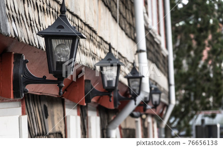 House wall in the old town with forged black iron lamps House wall in the old town with forged black iron lamps 76656138