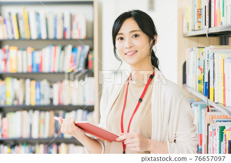 在圖書館看書的年輕女人 在圖書館看書的年輕女人 76657097