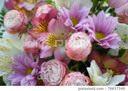 Floral background of various flowers: romantic bunch of fresh roses and alstroemeria close up 76657340