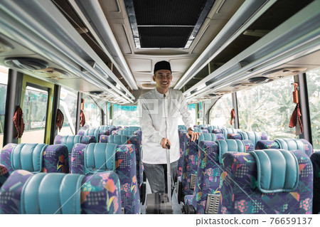 asian muslim man doing eid mubarak traveling back to his hometown by riding a bus 76659137