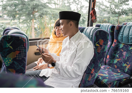 muslim couple travel by bus during eid mubarak holiday muslim couple travel by bus during eid mubarak holiday 76659160