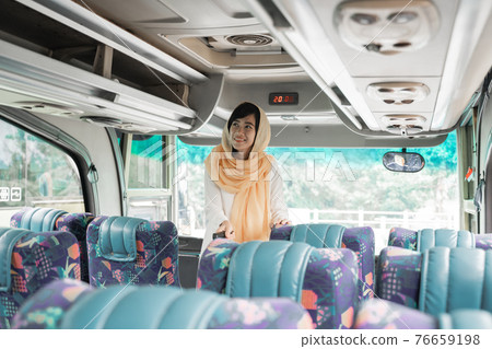 muslim woman doing eid mubarak traveling back to her hometown by riding a bus muslim woman doing eid mubarak traveling back to her hometown by riding a bus 76659198
