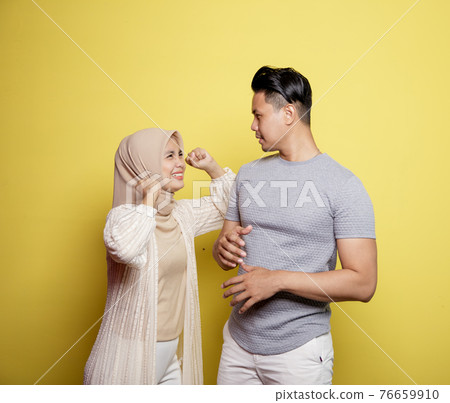 women wearing hijab happy to men smile with very happy expressions looking at each other 76659910