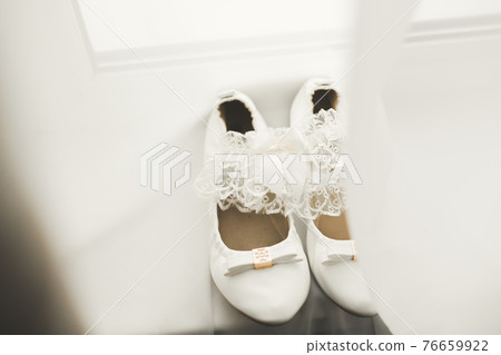 White stylish wedding shoes for bride. Close-up 76659922
