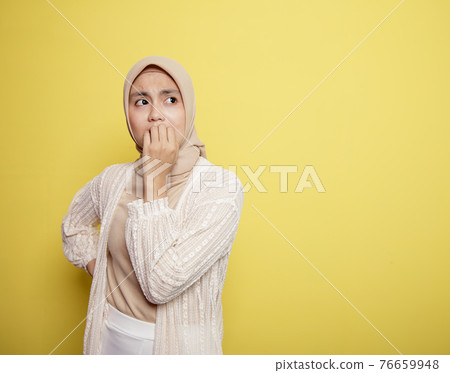 young woman wearing hijab with an expression scared young woman wearing hijab with an expression scared 76659948