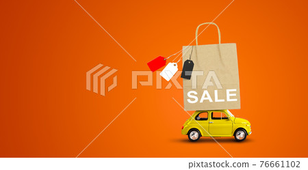 Yellow car with shopping paper bag from a sale on the roof Yellow car with shopping paper bag from a sale on the roof 76661102