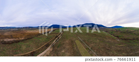 Panoramic landscape from the country road to the wind turbine, the development of wind energy in Ukraine. Panoramic landscape from the country road to the wind turbine, the development of wind energy in Ukraine. 76661911