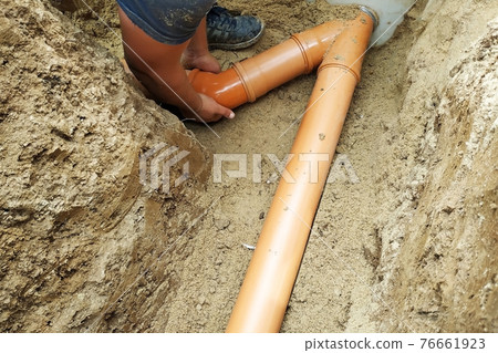 A locksmith supplies a sewer pipe to the sump. 76661923