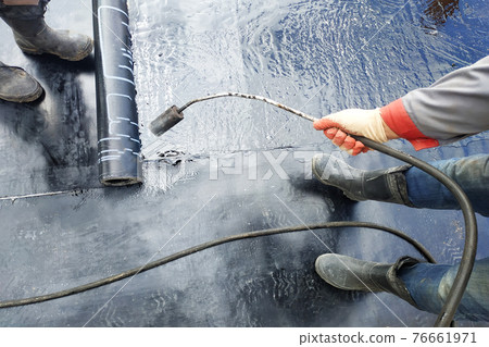 Professional installation of waterproofing on the concrete foundation Two worker at construction site. Professional installation of waterproofing on the concrete foundation Two worker at construction site. 76661971