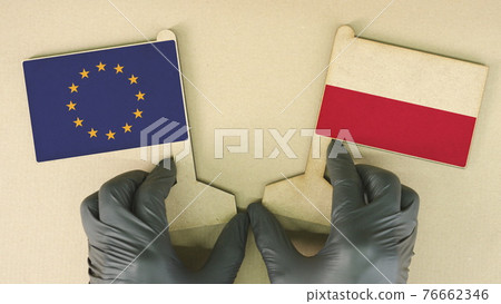 Flags of the European Union and Poland made of recycled paper on the cardboard table Flags of the European Union and Poland made of recycled paper on the cardboard table 76662346