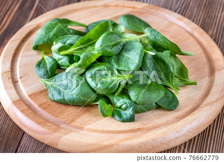 Fresh spinach on the wooden board Fresh spinach on the wooden board 76662779