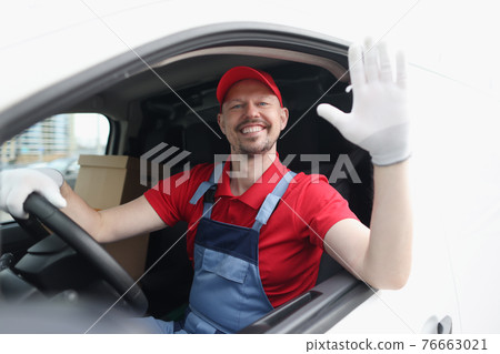 Smiling courier driver in car cab waving his hand in greeting Smiling courier driver in car cab waving his hand in greeting 76663021