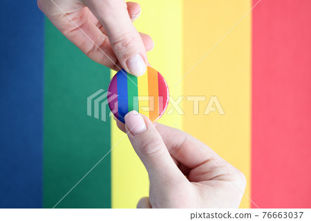 Lgbt sign in hands on background of flag 76663037