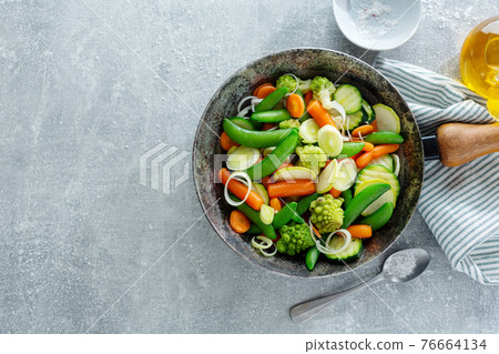 Vegan vegetables on pan on table Vegan vegetables on pan on table 76664134