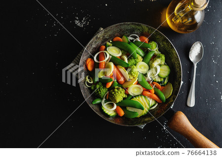 Vegan vegetables on pan on table Vegan vegetables on pan on table 76664138