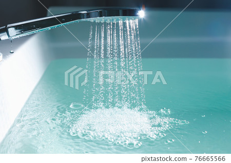 shower filling a bathtub with water stream 76665566