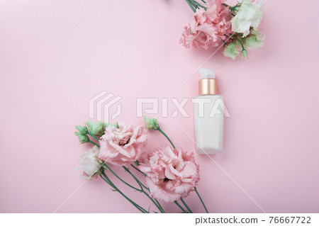 Face cream with fresh pink and white flowers, flatlay on pink background Face cream with fresh pink and white flowers, flatlay on pink background 76667722