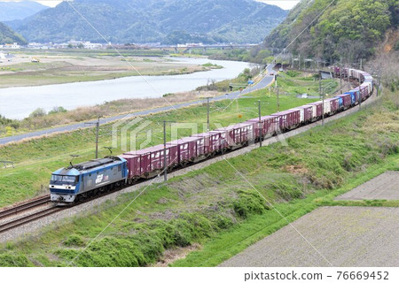 A long freight train that goes on the Sanyo Main Line with the Yoshii River in the background 76669452