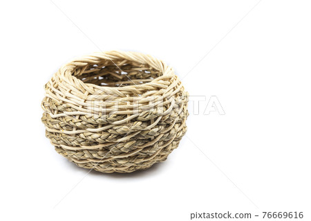 Small handmade wicker basket on white background 76669616