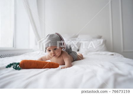 happy baby child in costume a rabbit bunny on a white background 76673159