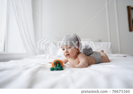 happy baby child in costume a rabbit bunny on a white background 76673160