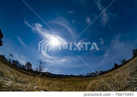 Sun ring and meadow 76673893