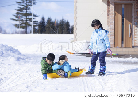 3 brothers playing in the snow 76677019