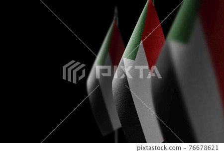 Small national flags of the Sudan on a black background 76678621