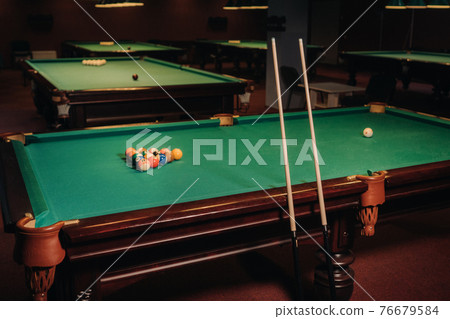 Billiard table with green surface and balls in the billiard club.Pool Game Billiard table with green surface and balls in the billiard club.Pool Game 76679584