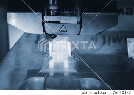 3D printer working and creating an object from the hot molten plastic 76680387