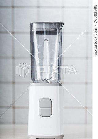 White electric blender on the kitchen table. White electric blender on the kitchen table. 76682999