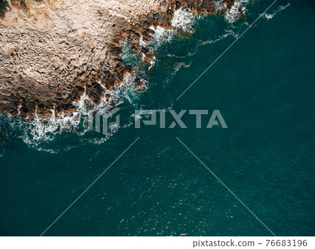 Aerial view of ocean waves and fantastic rocky coastline. Aerial view of ocean waves and fantastic rocky coastline. 76683196