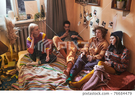 Young people gathering together at home 76684479