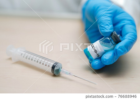 Novel Coronavirus (2019-nCoV) Covid-19 vaccine development medical with syringe for doctor use to treat pneumonia illness patients at Wuhan, China. 76688946