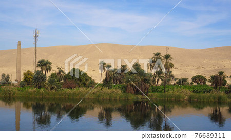 Egypt Nile river side view felucca boat and telephone signal tower Egypt Nile river side view felucca boat and telephone signal tower 76689311