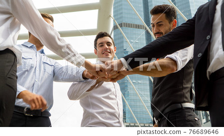 Business partners or group of diverse students put fists in circle fist bump as symbol of engagement in team building, support and synergy, help in cooperation, trust unity in teamwork, close up image Business partners or group of diverse students put fists in circle fist bump as symbol of engagement in team building, support and synergy, help in cooperation, trust unity in teamwork, close up image 76689646