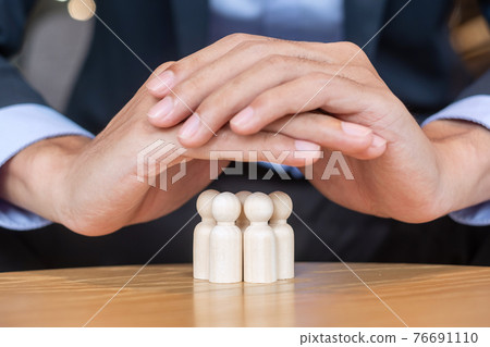 Businessman hand cover man wooden from crowd of employees. People, Business, Human resource management, Life Insurance, Teamwork and leadership Concepts Businessman hand cover man wooden from crowd of employees. People, Business, Human resource management, Life Insurance, Teamwork and leadership Concepts 76691110