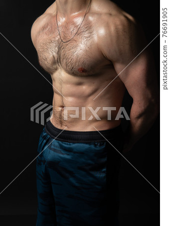 Man on black background keeps dumbbells pumped up in fitness bodybuilding biceps black, body muscular fitness athletic dumbbell, male weightlifting. Young sportive power, gym fit beautiful press with Man on black background keeps dumbbells pumped up in fitness bodybuilding biceps black, body muscular fitness athletic dumbbell, male weightlifting. Young sportive power, gym fit beautiful press with 76691905