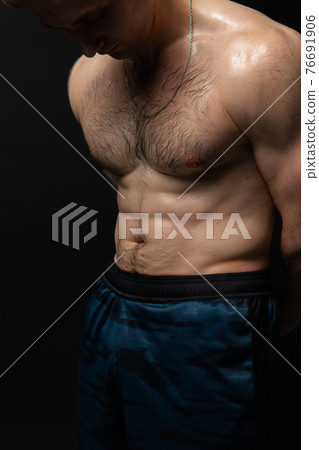 Man on black background keeps dumbbells pumped up in fitness active chest torso, training strong lifting powerful, shirtless pectoral. Lift skin power, guy fit beautiful press with hair Man on black background keeps dumbbells pumped up in fitness active chest torso, training strong lifting powerful, shirtless pectoral. Lift skin power, guy fit beautiful press with hair 76691906