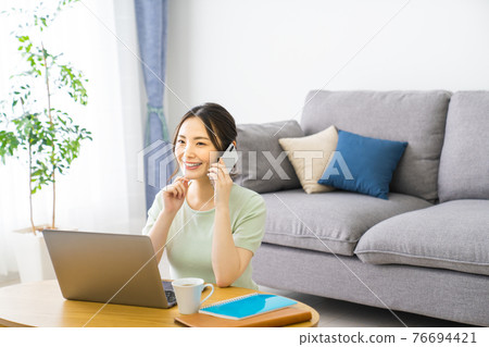Woman doing telework at home Woman doing telework at home 76694421