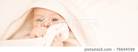 Cute small boy lying at bed. Childhood bath concept. Light background Cute small boy lying at bed. Childhood bath concept. Light background 76694599
