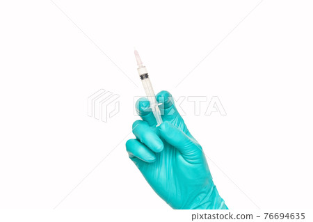 Person in green glove hold vaccine bottle syringe. Injection pharmacy concept 76694635
