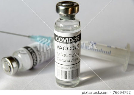 Coronavirus vaccine vials on white background 76694792